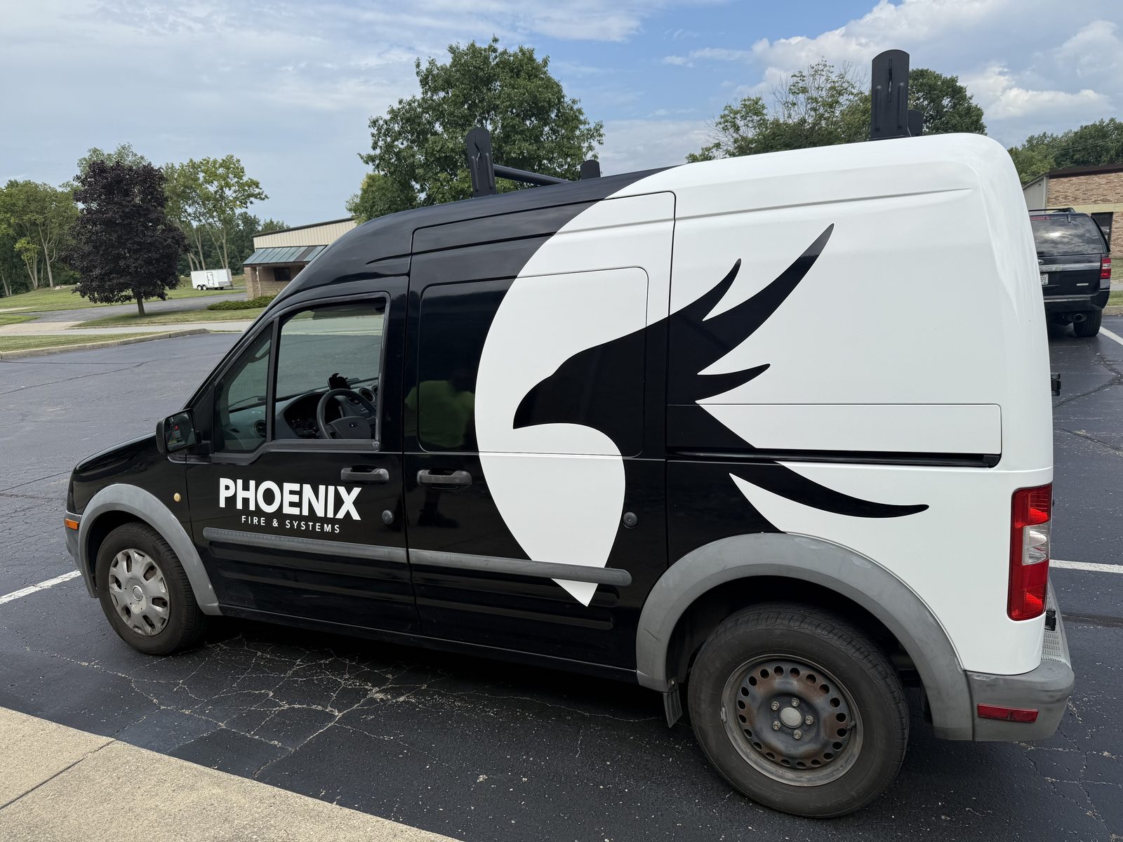 Phoenix Fire & Systems branded service van in the field